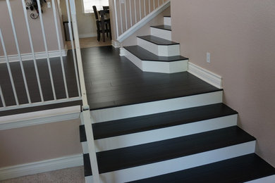 Mid-sized arts and crafts wooden straight wood railing staircase photo in Los Angeles with painted risers