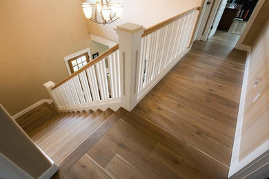 Inspiration for a modern wood railing staircase remodel in Other