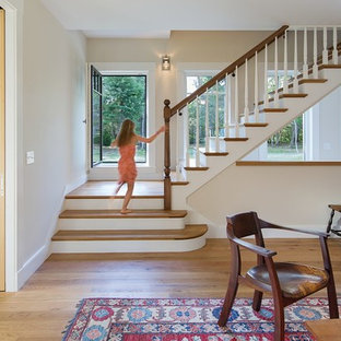 Example of a mid-sized country wooden l-shaped wood railing staircase design in Boston with painted risers