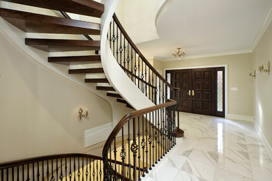 Example of a mid-sized classic wooden curved open staircase design in Chicago