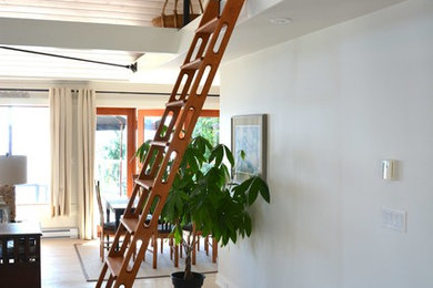 Small beach style wooden straight open staircase photo in Vancouver