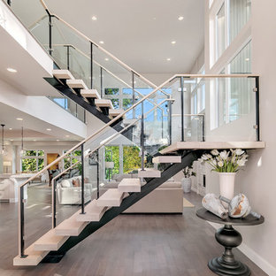 Example of a trendy wooden u-shaped open and glass railing staircase design in Seattle