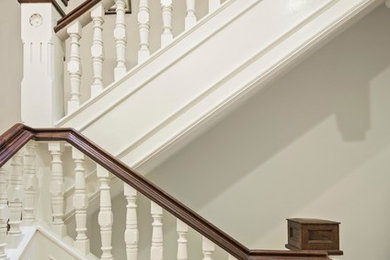 Staircase - traditional wood railing staircase idea in New York