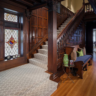 Staircase - large victorian carpeted u-shaped wood railing staircase idea in New York with wooden risers