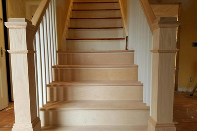 Mid-sized trendy wooden straight staircase photo in New York with wooden risers