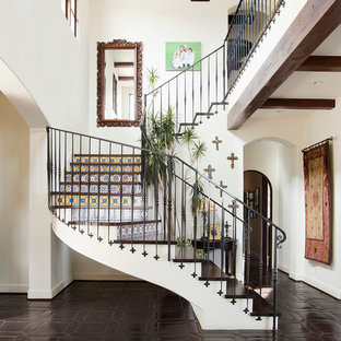 Inspiration for a mediterranean wood curved staircase in Los Angeles with tiled risers.