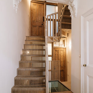 Inspiration for a scandi wood u-shaped wood railing staircase in London with wood risers.