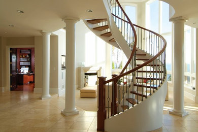 Inspiration for a large timeless wooden curved open and mixed material railing staircase remodel in DC Metro