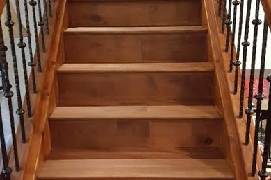 Inspiration for a rustic wooden straight staircase remodel in Denver with wooden risers