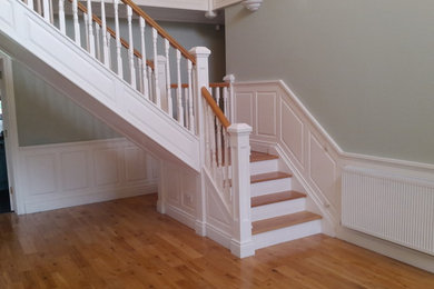 Staircase - mid-sized traditional wooden l-shaped staircase idea in New York with painted risers