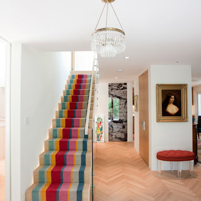 Staircase - eclectic wooden straight glass railing staircase idea in Vancouver with wooden risers