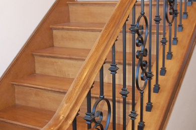Mid-sized elegant wooden u-shaped mixed material railing staircase photo in Los Angeles with wooden risers