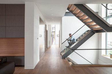 Mid-sized minimalist wooden u-shaped open and glass railing staircase photo in Chicago