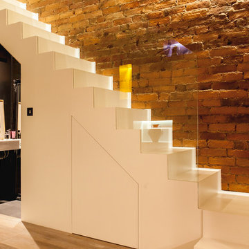 Minimalist staircase with hidden under-stair cloakroom