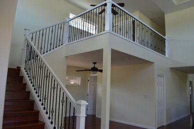 This is an example of a medium sized classic wood l-shaped staircase in Hawaii with wood risers.