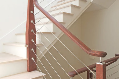 Mid-sized minimalist wooden curved staircase photo in Boston with wooden risers