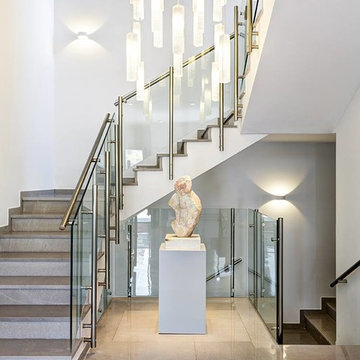 MODERN FOYER CHANDELIER IN TWO LEVEL STORY STAIRCASE