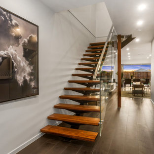 Design ideas for a mid-sized contemporary wood l-shaped staircase in Brisbane with open risers and glass railing.