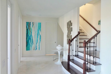 Inspiration for a medium sized traditional wood l-shaped mixed railing staircase in Miami with painted wood risers.