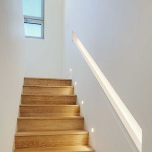 Inspiration for a large contemporary wooden u-shaped staircase remodel in Boston with wooden risers
