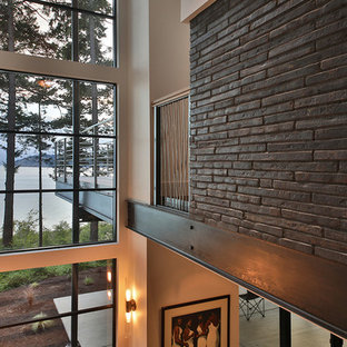Example of a large minimalist wooden straight open and mixed material railing staircase design in Seattle