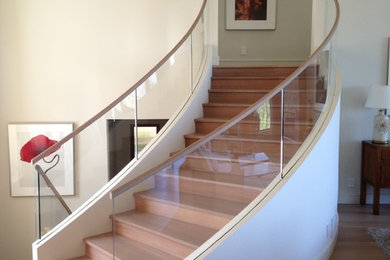 Medium sized modern wood curved staircase in San Francisco with wood risers and feature lighting.