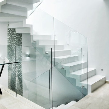 Modern white staircase with mosaic wall