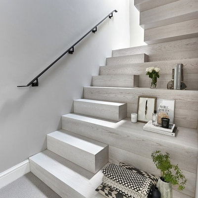 Staircase - mid-sized contemporary wooden u-shaped metal railing staircase idea in Other with wooden risers