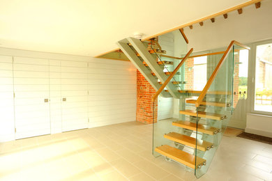 Photo of a modern wood staircase in Other with open risers.