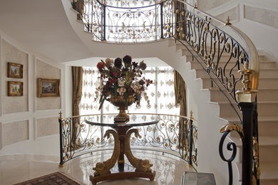Inspiration for a huge victorian marble curved metal railing staircase remodel in Other with marble risers