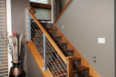 Example of a mid-sized arts and crafts wooden u-shaped staircase design in Other with tile risers