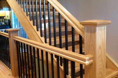 Foto de escalera recta de estilo americano de tamaño medio con escalones de madera y contrahuellas de madera