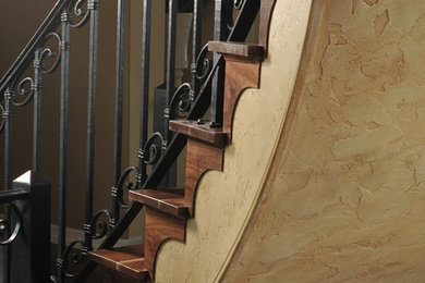 Staircase - mid-sized traditional wooden curved staircase idea in Denver with wooden risers