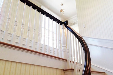 Example of a mid-century modern wooden curved staircase design in Boston with wooden risers