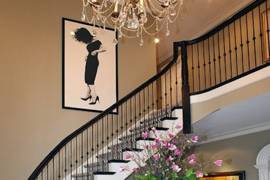 Inspiration for a large wooden curved staircase remodel in Milwaukee with carpeted risers
