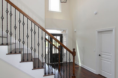 Mid-sized transitional wooden straight metal railing staircase photo in Nashville with wooden risers
