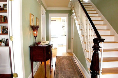 Mid-sized elegant wooden straight staircase photo in Milwaukee with painted risers