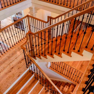 This is an example of an expansive traditional wood floating staircase in DC Metro with wood risers.
