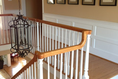 Example of a huge classic wooden spiral staircase design in Philadelphia with wooden risers