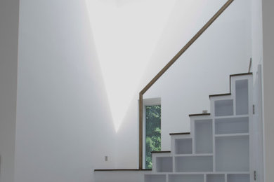 Design ideas for a contemporary staircase in London with under stair storage.