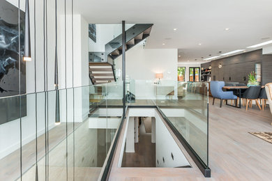 Example of a large trendy straight glass railing staircase design in San Francisco
