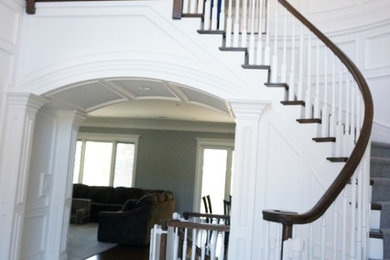 Staircase - mid-sized traditional wooden curved staircase idea in Chicago with painted risers