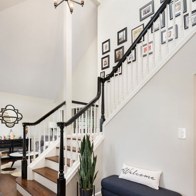 Inspiration for a large transitional wooden l-shaped wood railing staircase remodel in Seattle with wooden risers