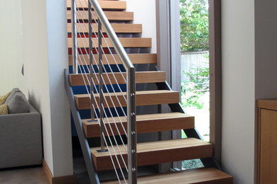 Diseño de escalera recta minimalista pequeña sin contrahuella con escalones de madera