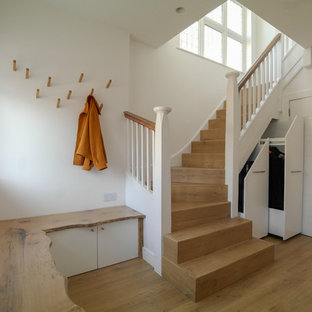 Photo of a traditional wood u-shaped wood railing staircase in London with wood risers.