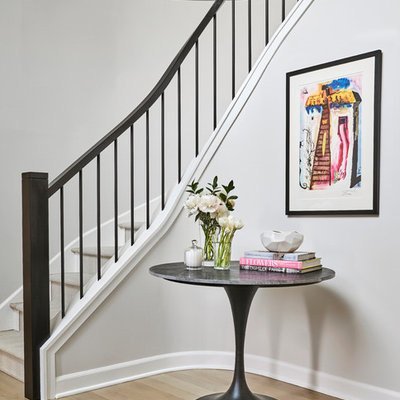 Transitional curved metal railing staircase photo in Chicago