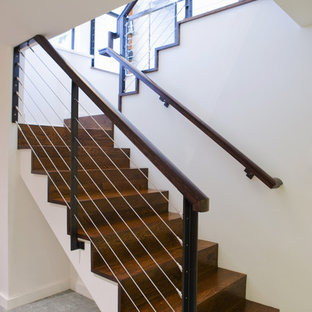 Minimalist wooden cable railing staircase photo in Portland with wooden risers