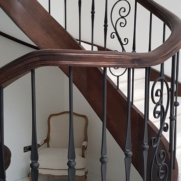 Oak Stained staircase with wrought iron spindles