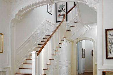Example of a classic wooden wood railing staircase design in Tampa with painted risers