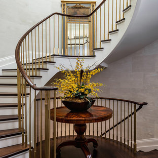 Staircase - traditional wooden curved staircase idea in Toronto with painted risers